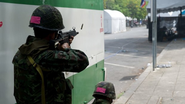 Thai soldiers fire on Red-shirt protesters during the military crackdown to end the Red-shirt unrest.