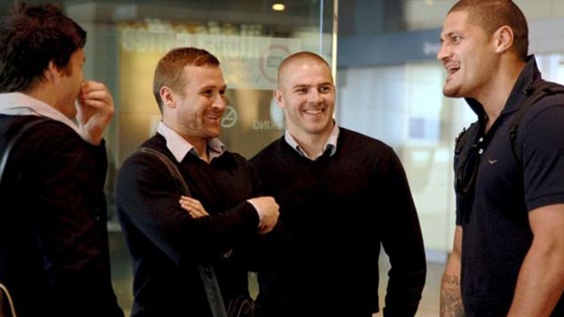 Did you hear the one about ... Wallabies Matt Giteau and Drew Mitchell shoot the breeze with NRL player Willie Mason at Sydney Airport yesterday.