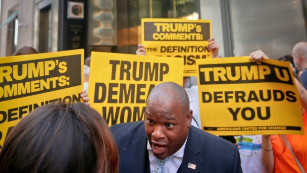 Donald Trump supporter Mark Burns, an evangelical pastor from South Carolina, is surrounded by vocal anti-Trump protesters.