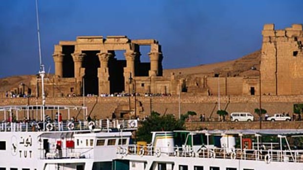 Age of contrasts ...  a cruise ship passes the ruins of Kom Ombo.