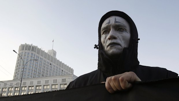 An activist holds a banner during a rally on World AIDS day to protest against government policies, in front of the Russian White House in Moscow in 2010. 