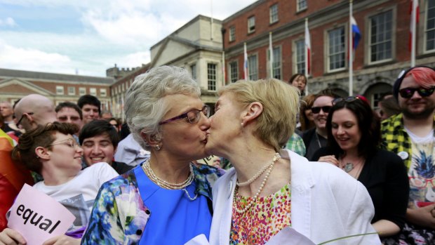 Same-sex marriage supporters kiss at Dublin Castle in Dublin.