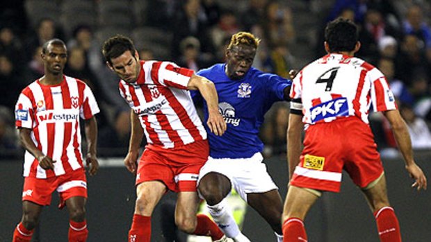 Everton's Louis Saha battles against the numbers last night.