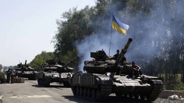 Pressing the rebels ... Ukrainian troops and tanks patrol near the eastern Ukrainian city of Debaltseve in the Donetsk region.