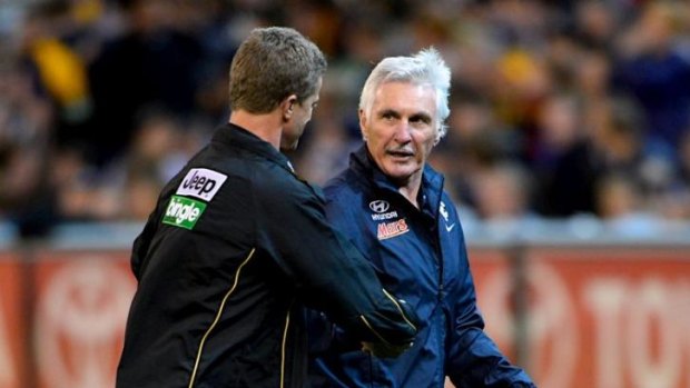 Coaches Damian Hardwick and Mick Malthouse shake hands before the first bounce