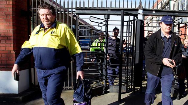 Slow down ... Ford workers leave the Geelong plant after being told some will lose their jobs.