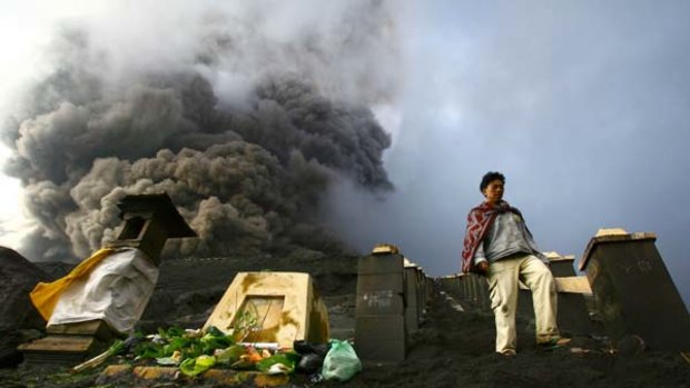 A worshipper descends from the crater of Mount Bromo in East Java after making offerings to the god of the mountain.