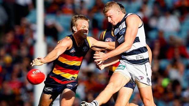 Geelong's Taylor Hunt kicks under pressure from Nathan van Berlo of the Crows. Heavyweight Geelong suffered a comprehensive defeat at the hands of Adelaide, the precocious up-and-comer.