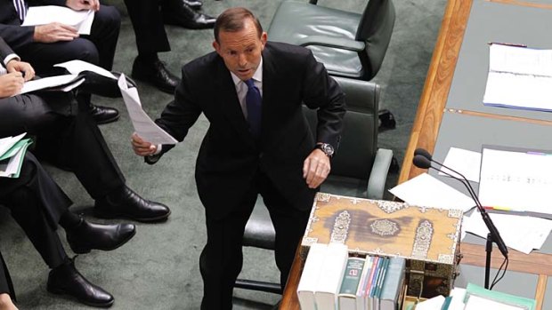 Leader of the Opposition Tony Abbott tables the power bill during Question Time.