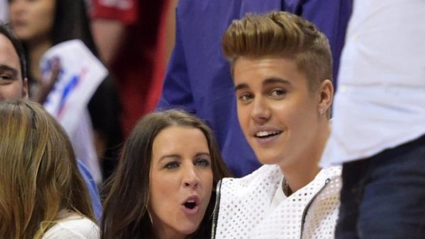 Troubled times ... Singer Justin Bieber, right, watches the Los Angeles Clippers play the Oklahoma City Thunder with his mother Pattie Mallette. 
