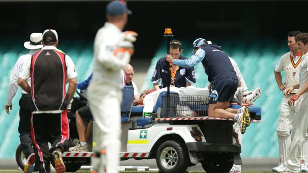 Phil Hughes is stretchered off the SCG.