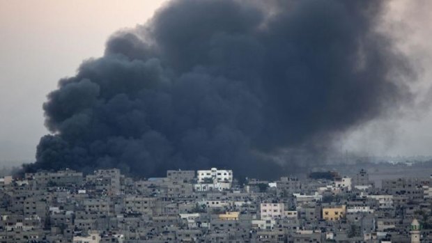 Smoke billows from a building hit by an Israeli air strike in Gaza City on July 25.