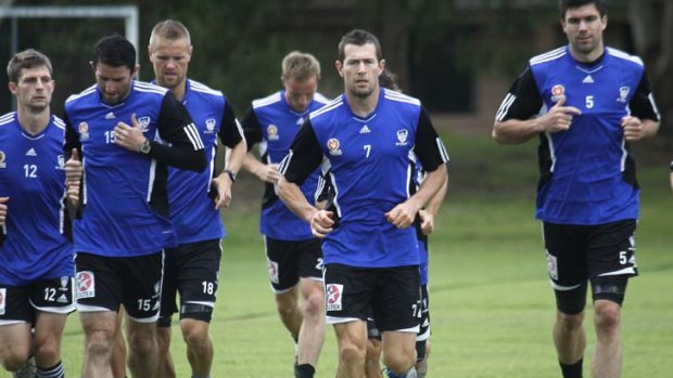 One of the lads &#8230; Brett Emerton, right, recognised as more of a team player than his high-profile fellow Socceroo, steps out with his Sydney FC teammates during a training run.