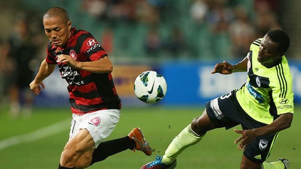 On the move: Western Sydney's Shinji Ono and Victory's Adama Traore battle for the ball at Parramatta.