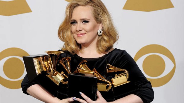 Adele poses backstage with her six awards at the 54th annual Grammy Awards.