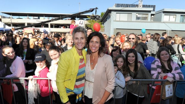 Contestants Katrina and Amie with huge crowds queuing to inspect the houses.