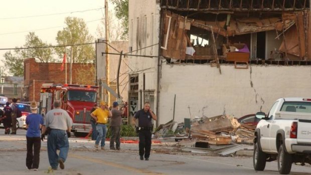 Volunteers and firemen gather in storm-hit Quapaw, Oklahoma, on Sunday evening.