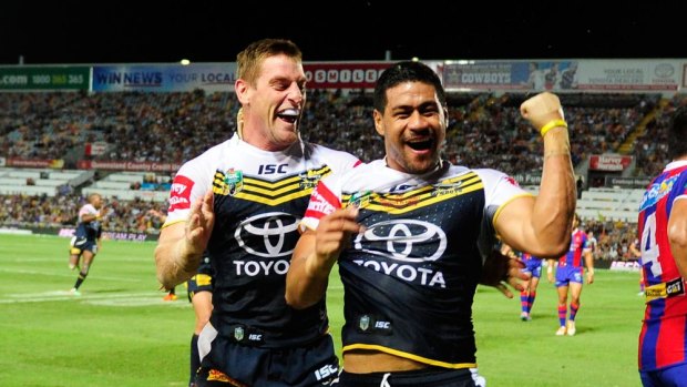 Matthew Wright celebrates his try with Brent Tate in North Queensland's thumping win over Newcastle in Townsville on Monday night.