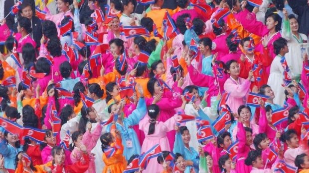 Cheerleaders from North Korea in traditional dress cheer at the opening cermony for a previous Asian Games in 2002, in Busan, South Korea.   