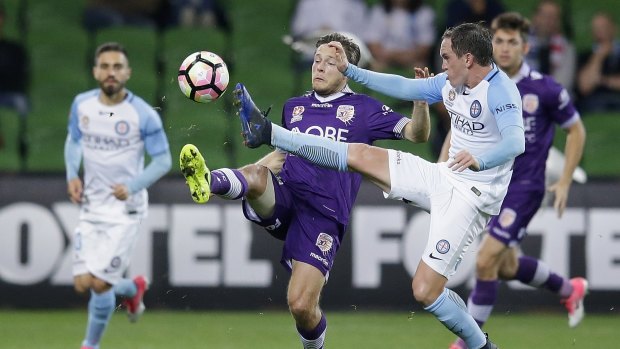City's Neil Kilkenny and Perth's Chris Harold of Perth Glory compete for the ball.