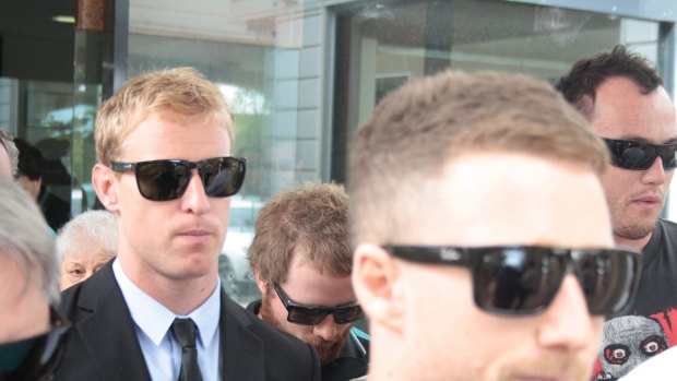 Matt Blackford (in suit) leaves court after being found guilty of an on-field assault.