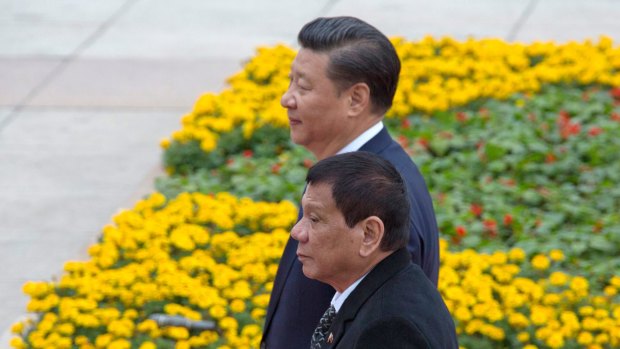 Philippine President Rodrigo Duterte, front, walks with Chinese President Xi Jinping outside the Great Hall of the People in Beijing, China this week.
