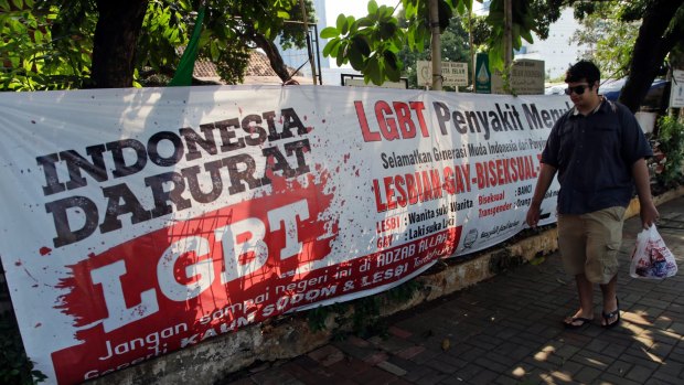 A man walks past an anti-LGBT banner erected by an ultra-conservative Islamic group in Jakarta during the Constitutional Court hearings in 2016.