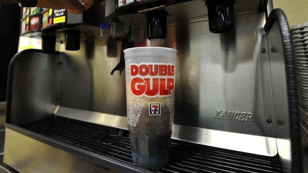 A man gets a Double Gulp drink at a US 7-11 store.
