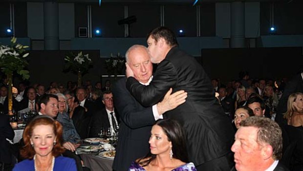 Congratulatory hug ... Alan Jones is embraced by James Packer. In front are Deeta Colvin, Erica Packer and Phil Gould.
