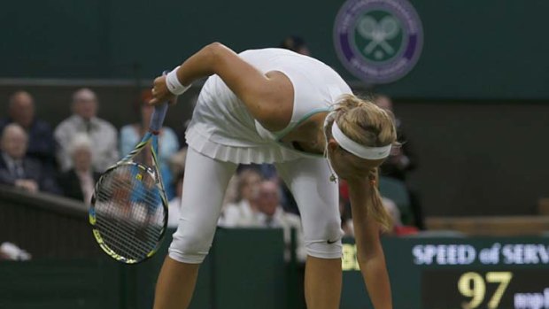 Unusual droppings ... Victoria Azarenka of Belarus picks up feathers from the court.