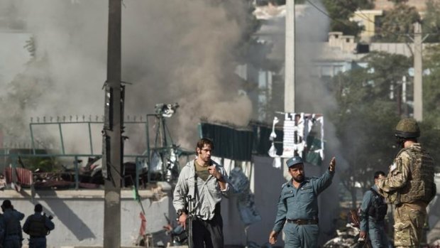 Bomb site: officials inspect the damage in central Kabul.
