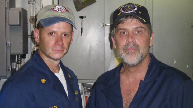Free ... Richard Phillips, right, shakes hands with David Fowler, executive officer of USS Bainbridge.