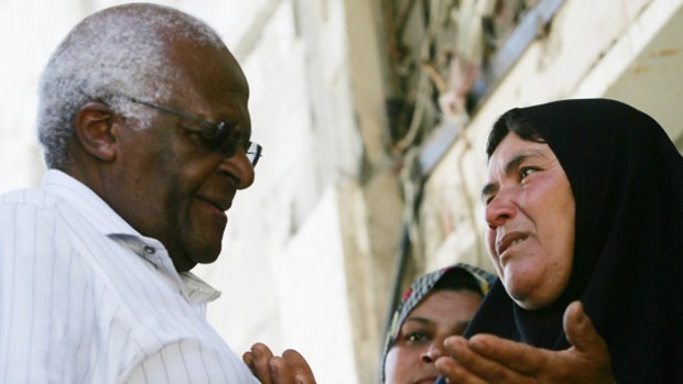 Archbishop Tutu with a member of the Athamneh family.