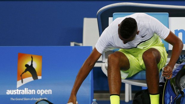Smash it up: Nick Kyrgios breaks a racquet on Monday night.