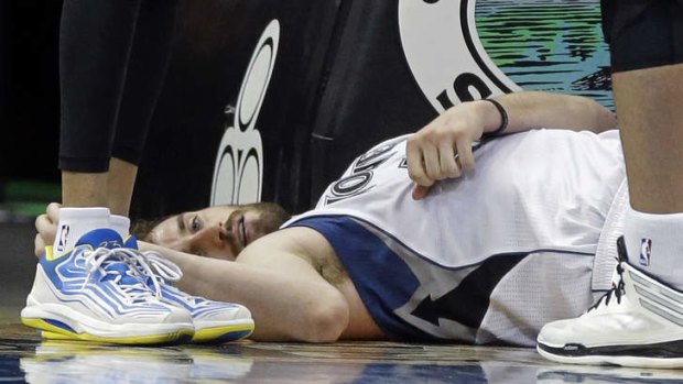 Minnesota Timberwolves forward Kevin Love lies on the court after falling and hitting his head after he was fouled by Los Angeles Lakers opponent Robert Sacre while attempting a shot in the second half in Minneapolis. The Timberwolves won 109-99. Love led his team with 31 points and 17 rebounds.