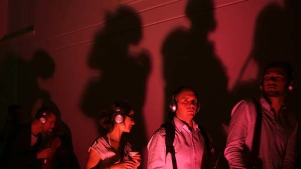 Dancing to beat of own headphones ... Anna Moldt and Duncan Livingstone, middle, at the Australian Museum's silent disco.