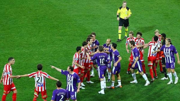 Melbourne Heart and Perth Glory players scuffle during their 2-2 draw at AAMI Stadium yesterday.