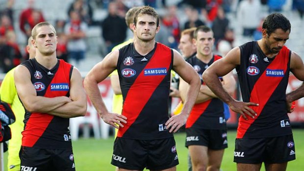 Weary: Essendon captain Jobe Watson (centre) shows his disappointment.