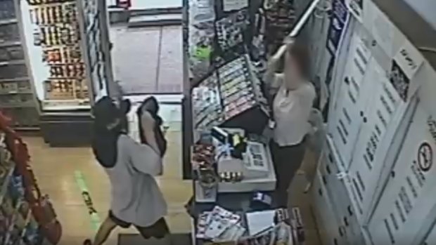 A woman has fought back against an armed robber, fending him off with a metal pole.