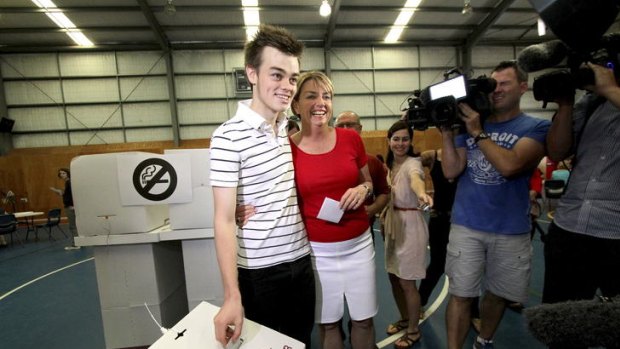 "Tough day" ... Anna Bligh casts her vote with son Oliver.