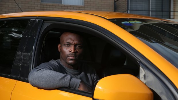 Mike Oze in one of his two cars that he bought on loan as an Uber driver. Uber have since dismissed him as a driver. 