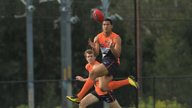 Start of a long road ... big-name recruit Israel Folau shapes up to the Sherrin at a Greater Western Sydney Giants training session yesterday.