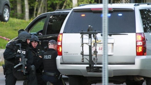 Emergency Response team members take cover in Moncton, Canada.