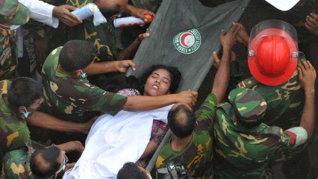 Bangladeshi soldiers evacuate a survivor after she was recovered, 60 hours later, from the rubble of a collapsed eight-storey building in Savar, on the outskirts of Dhaka.
