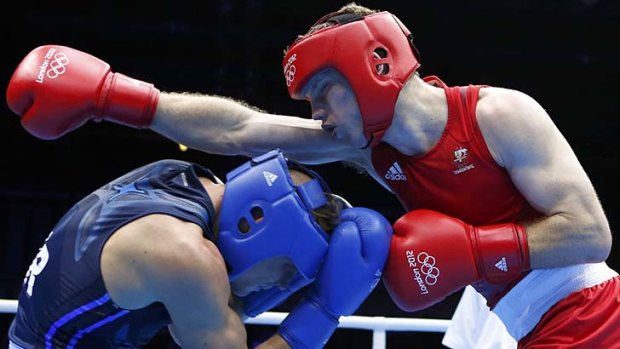 Swing and a miss ... Australia's Jeffrey Horn (in red) fights Ukraine's Denys Berinchyk.