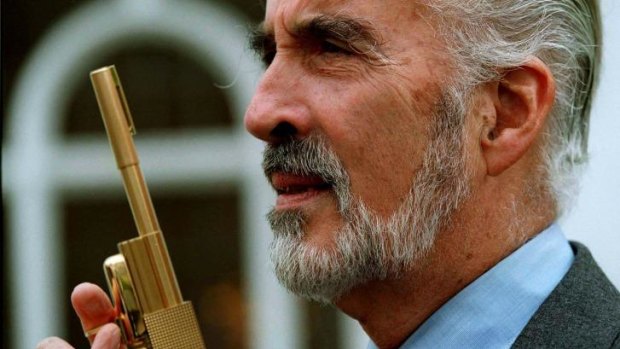 Christopher Lee, who played villian Scaramanga in the James Bond movie The Man With The Golden Gun poses with the original gun.