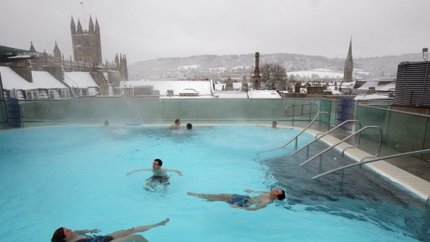 Bathers enjoy the rooftop pool at the Thermae Bath Spa.