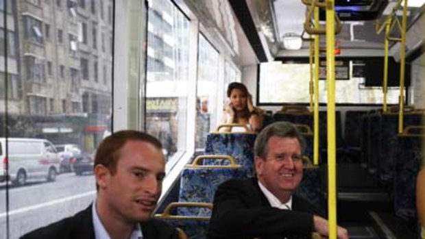Declaring his hand...Barry O'Farrell rides the bus to Randwick with the Liberal candidate Bruce Notley-Smith yesterday.