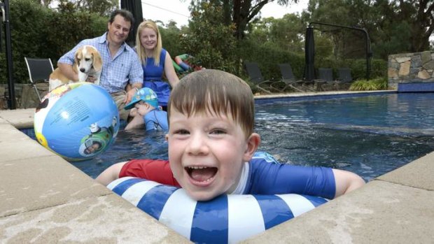 ENFORCED LEISURE: Matt Bullock with Wendy Bullock, Edmund, 2, and Oscar (foreground), 4, by the pool at their Pearce home with dog Harper.