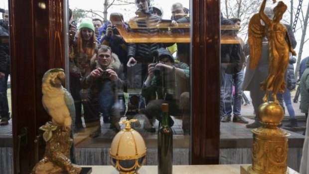 People look through windows of the Mezhyhirya residence of Ukraine's President Viktor Yanukovich on February 22.